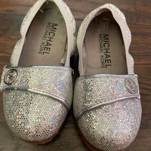 Michael Kor’s flat and sandals.